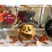 This is a Halloween pumpkin decoration. It is a carved gourd with a black top hat. His name is Mr. Willably. 